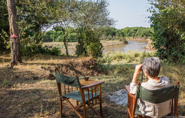 Around the fire at Hammerkop Migration on the Mara River. Masai Mara Game Reserve